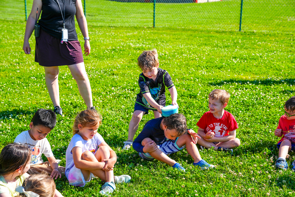 A Milford preschool student getting another student wet with a sponge