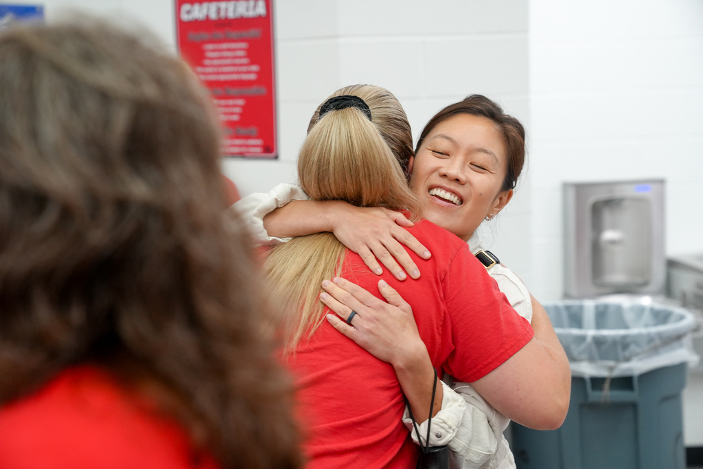 Two Milford staff members share a joyful hug during the annual staff convocation.