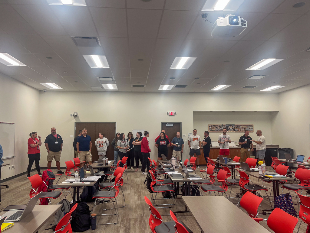 Milford staff members gather in a large conference room
