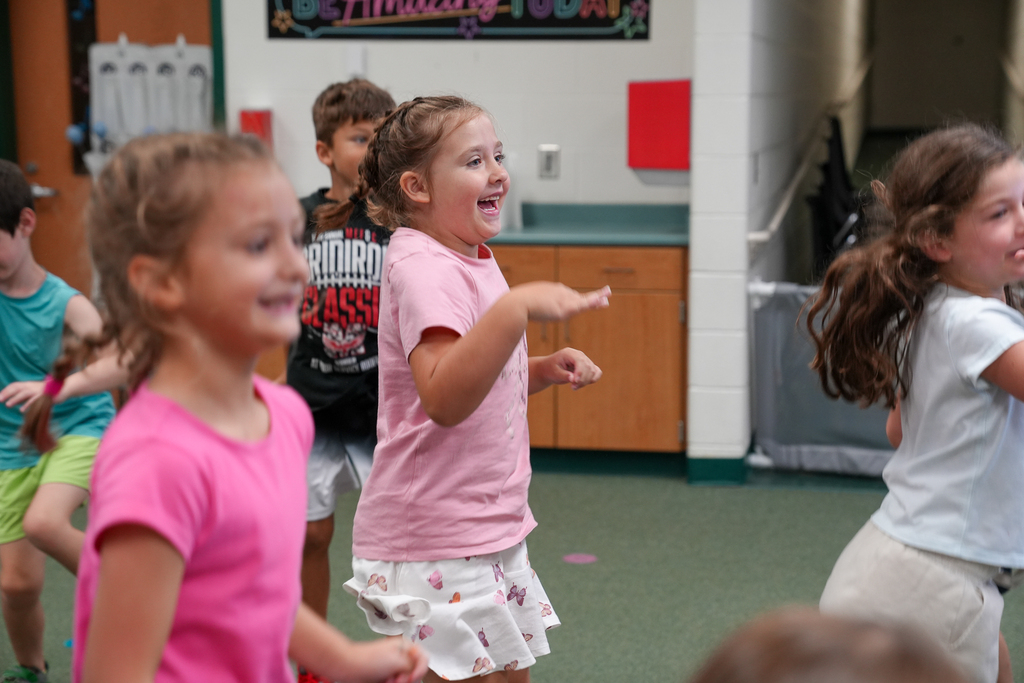 Elementary students smile and move around during a classroom activity at Mulberry Elementary.