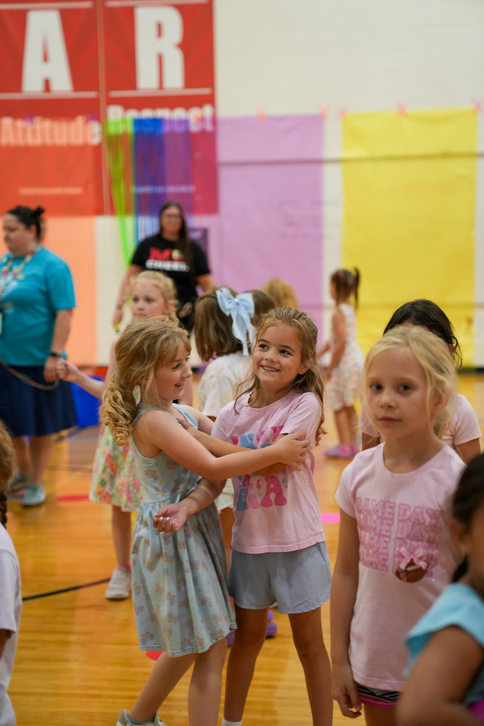 Seipelt students smile and dance together in the school gym during the walk-a-thon celebration.