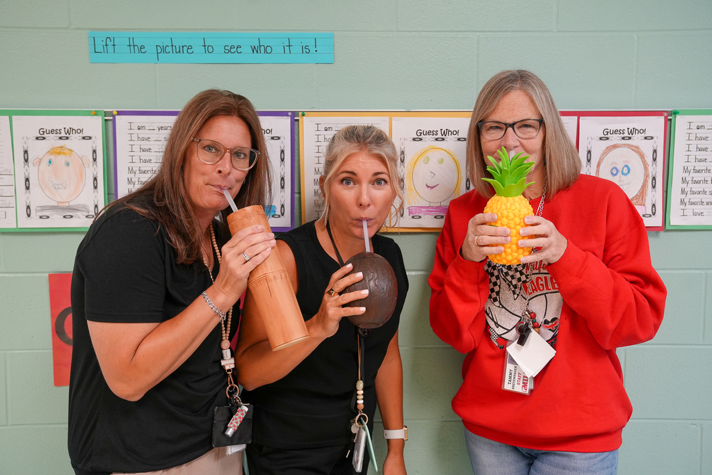 Three staff members drink from a bamboo-style cup, coconut-shaped cup and pineapple-shaped cup.