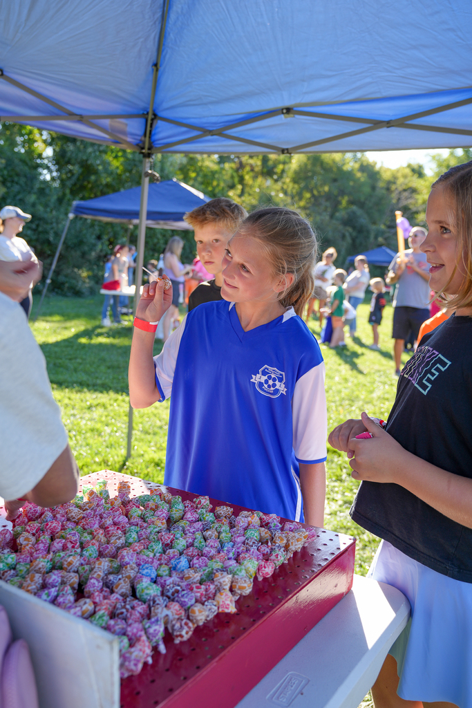 Students select prizes from a table filled with colorful candy during McCormick Fest.