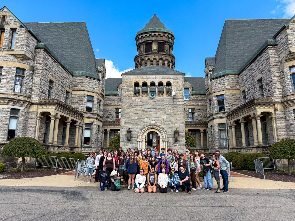 Milford theatre students and staff pose outside the stone entrance of the Ohio State Reformatory.
