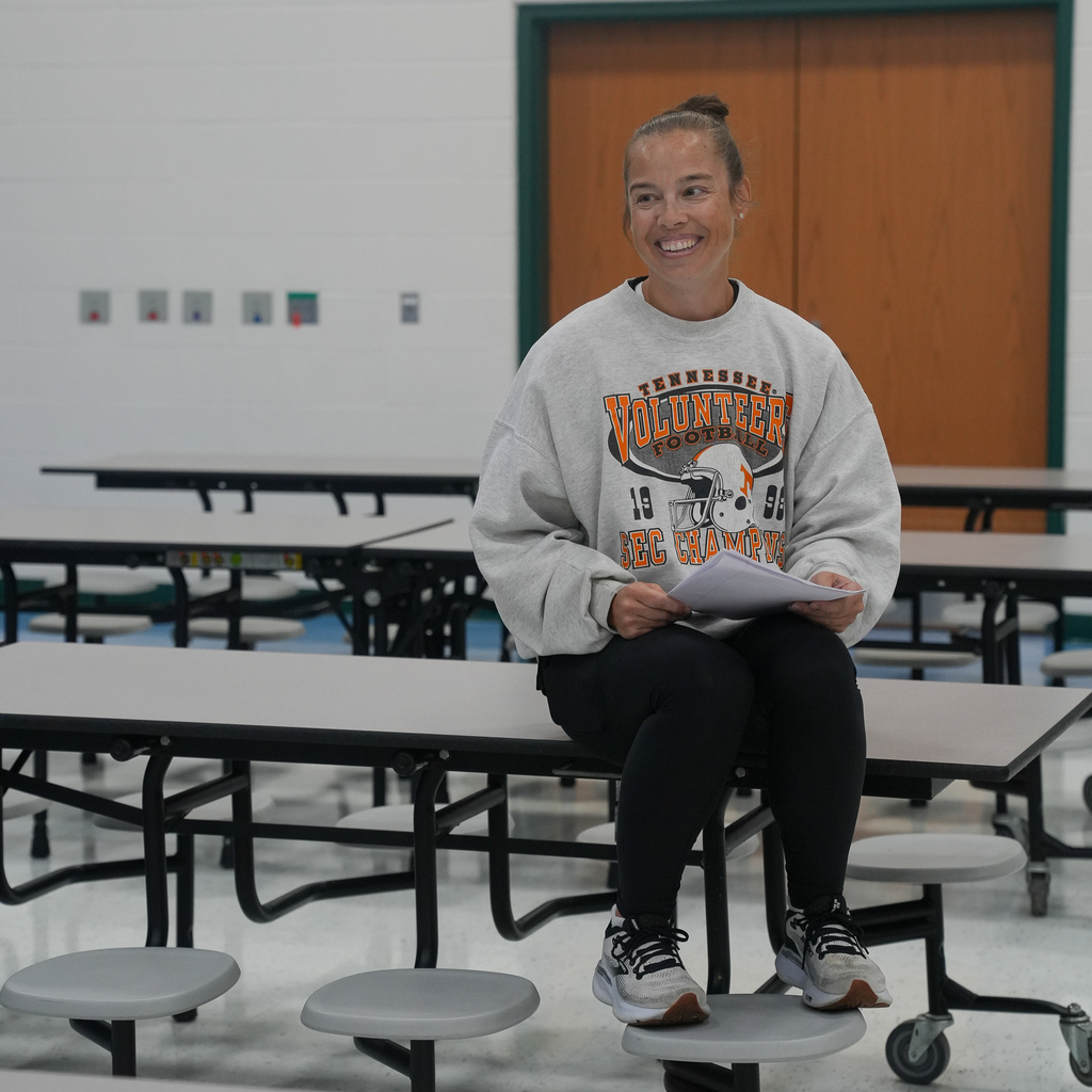 A McCormick Elementary staff member smiles while holding written instructions during a lesson on following steps in the correct order.