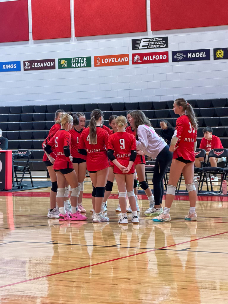 Group of Middle School Volleyball Girls learning from their coach
