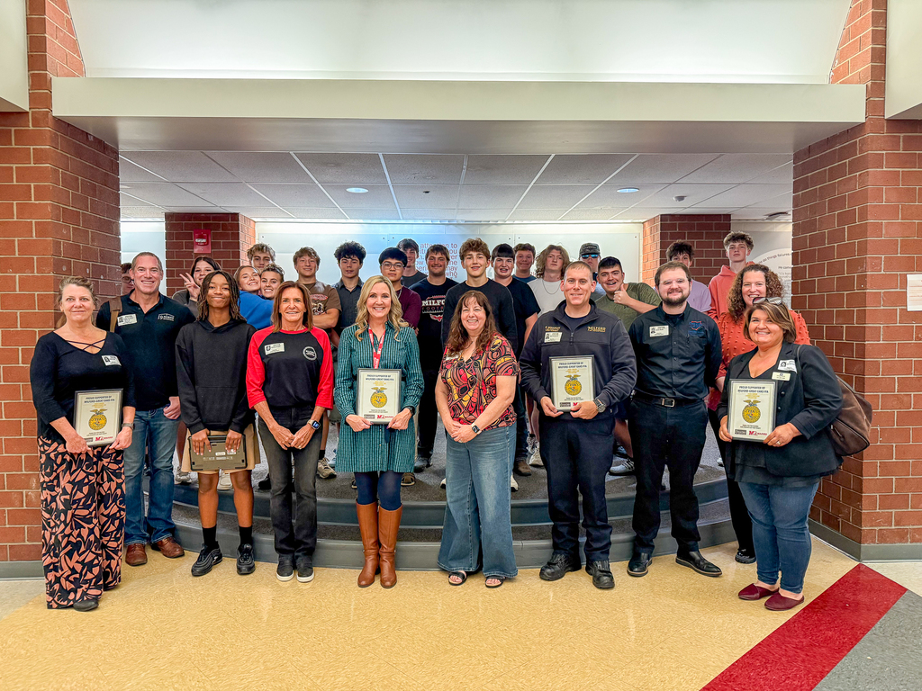 Group of all the FFA students and local business partners holding FFA signs