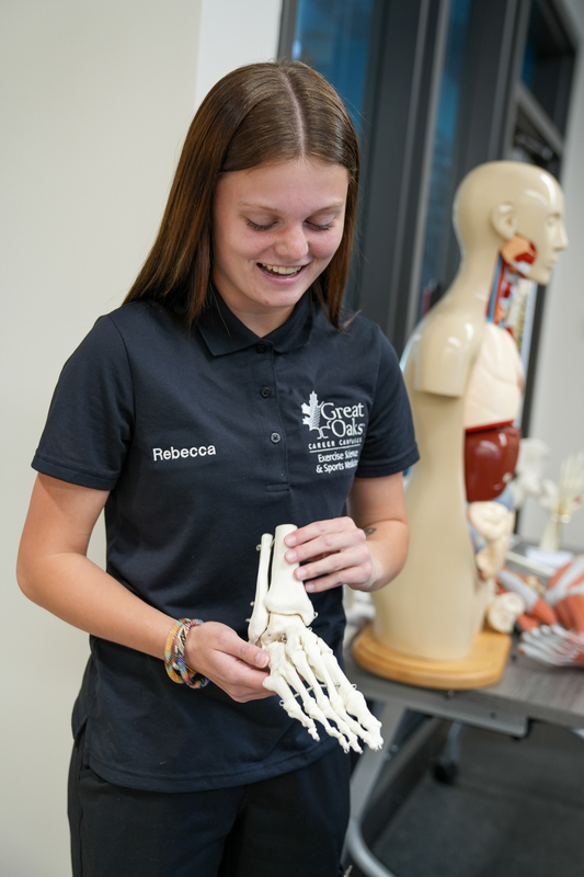 A student holding a skeleton foot