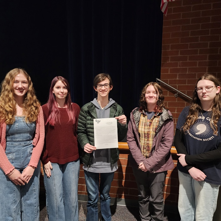 students holding an award 