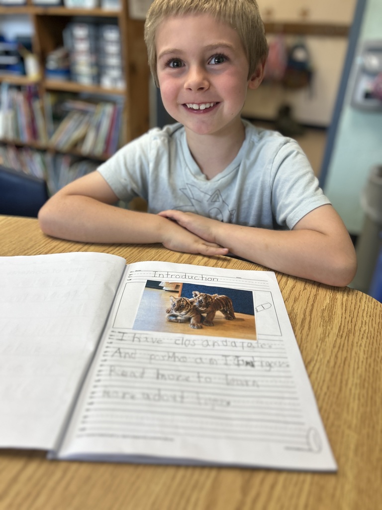 Student showing off his book.