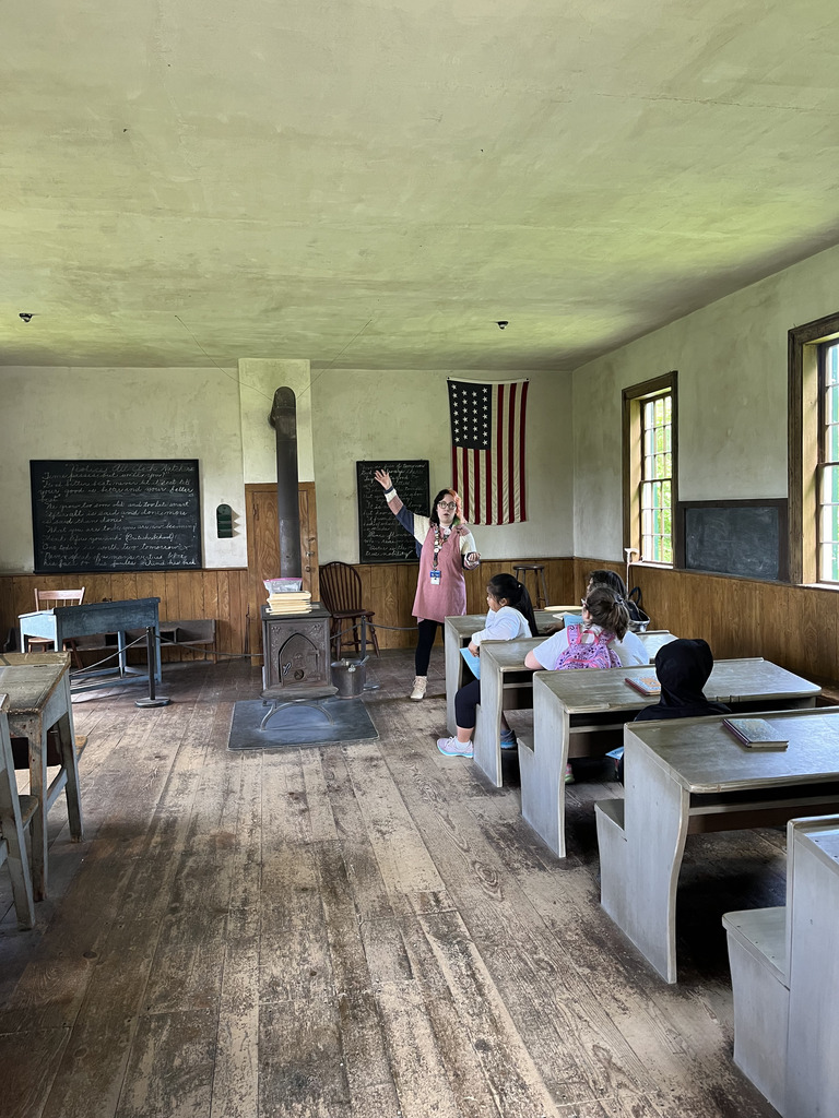 Students tour a schoolhouse.