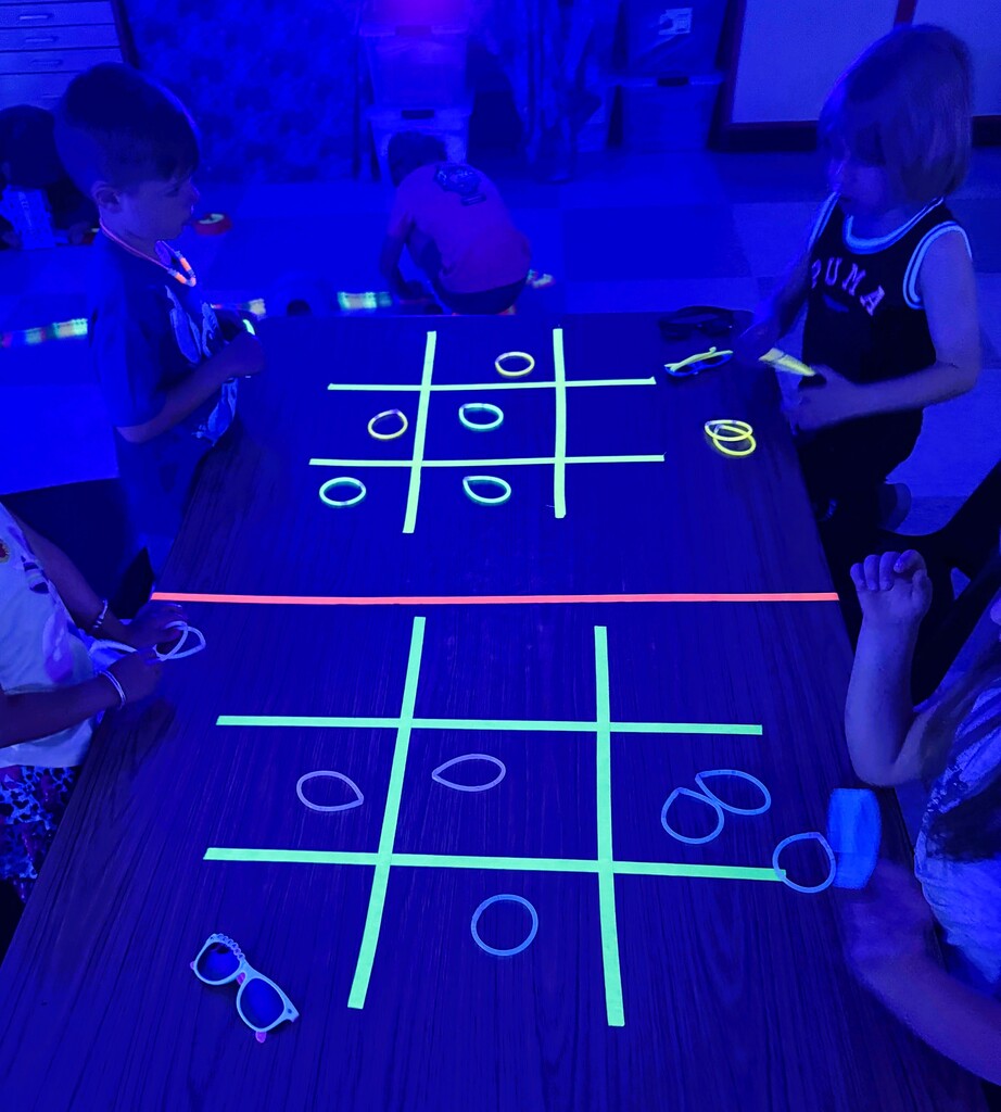 Students playing glow in the dark tic-tac-toe