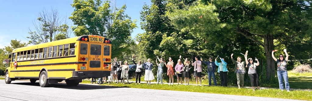 Teachers waving to buses