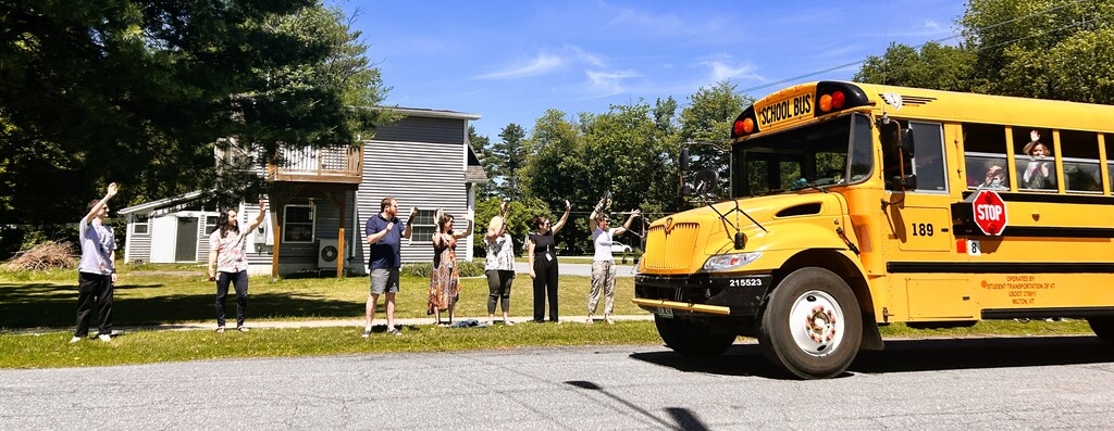 Teachers waving to buses