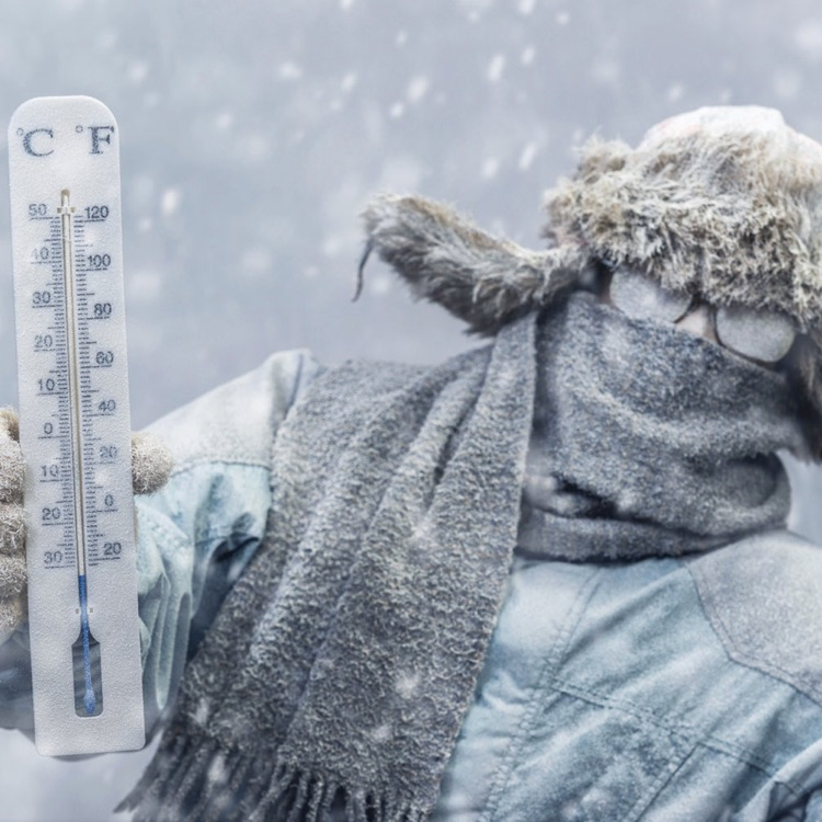 Person holding outdoor thermometer