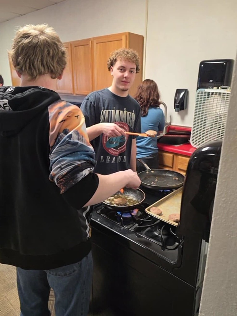 Tayson and Bryant cookiing breakfast for FFA Staff breakfast