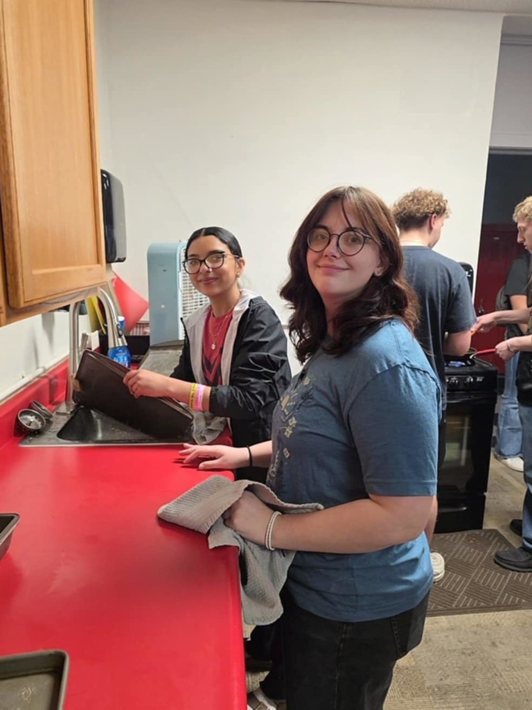 Jenessa and Thalia cookiing breakfast for FFA Staff breakfast