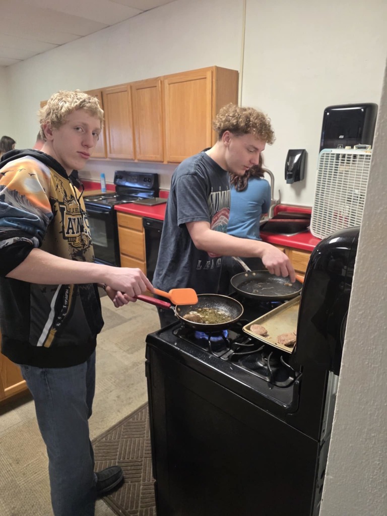 Bryant and Tayson cookiing breakfast for FFA Staff breakfast