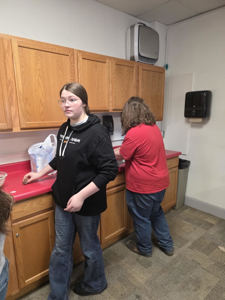 Bayleigh and Aaron cookiing breakfast for FFA Staff breakfast