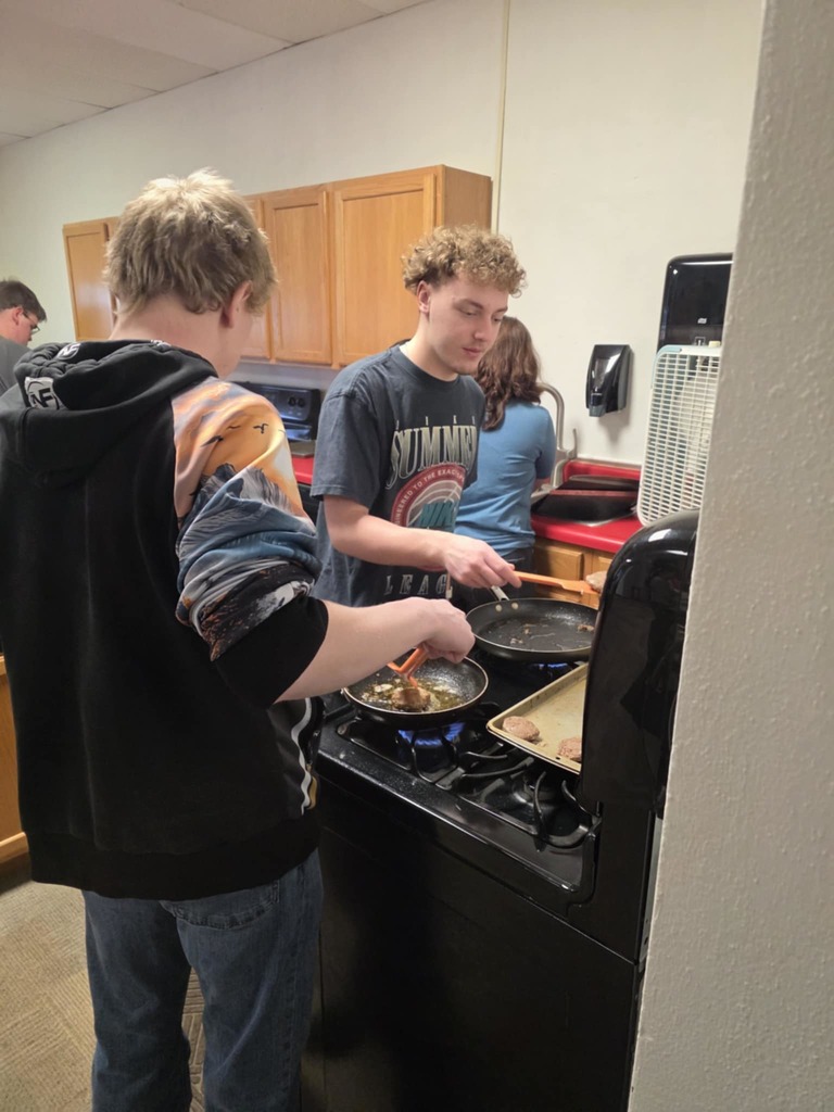 Tayson and Bryant cookiing breakfast for FFA Staff breakfast
