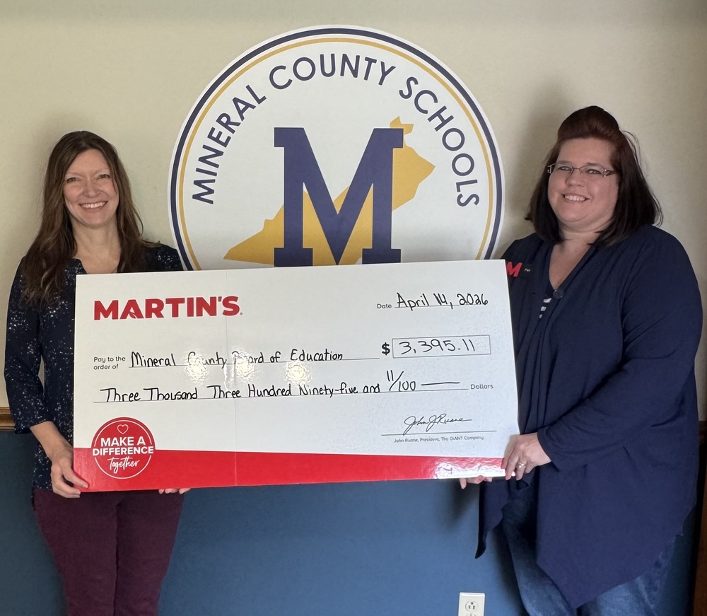 Martins Foods presents check for Feeding School Kids Initiative.  Shown are MCS Treasurer Rhonda Martin and Store Manager Faith Everline.