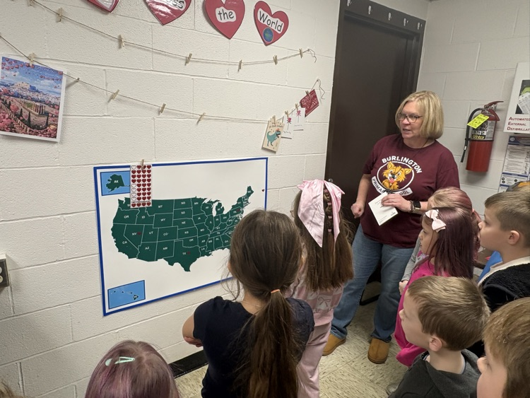 Miss Jenn’s Kindergarten class reviewing their  Hearts Across the World map. 