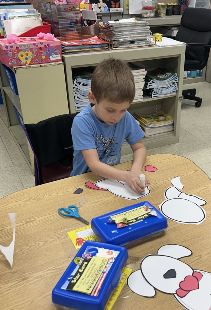 Photo of student making a Dalmatian craft.