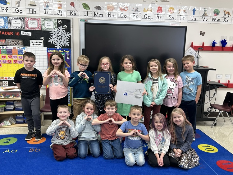 Photo of students holding the envelope from the governor.