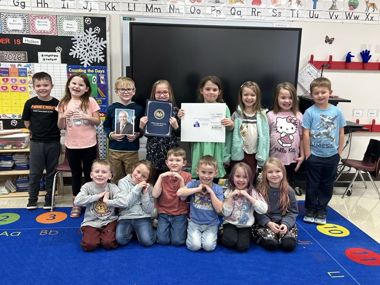 Photo of students holding card.