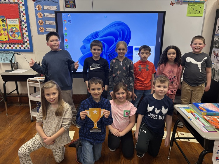 Photo of 2nd graders holding their Perfect Attendance Challenge trophy.