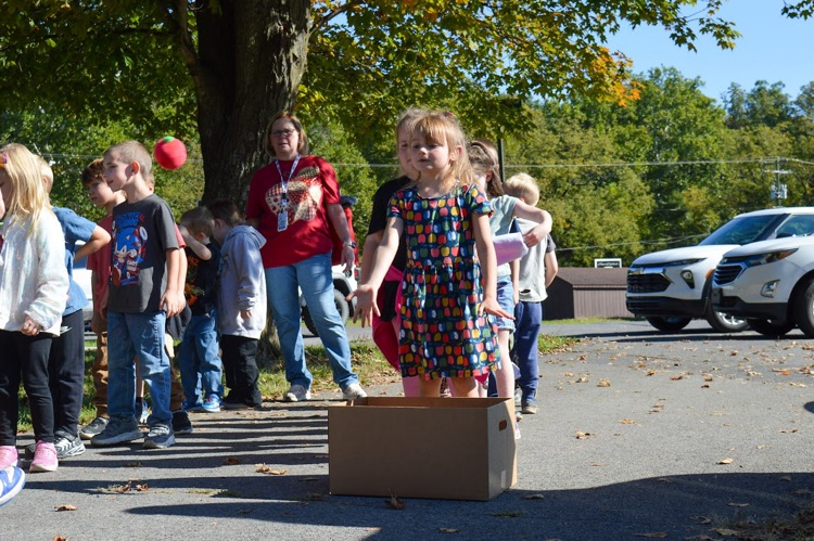 A photo of a student playing Apple Toss.