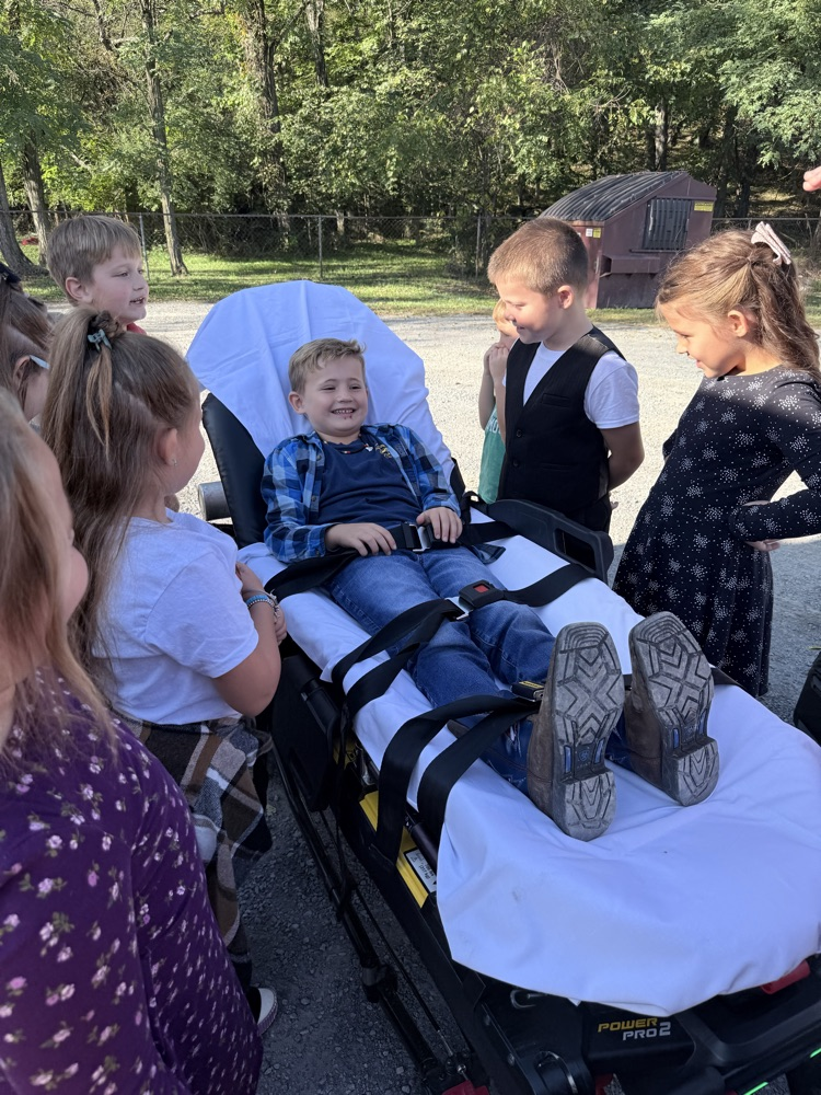 A photo of a student lying down on the ambulance stretcher at the Fire Safety presentation.