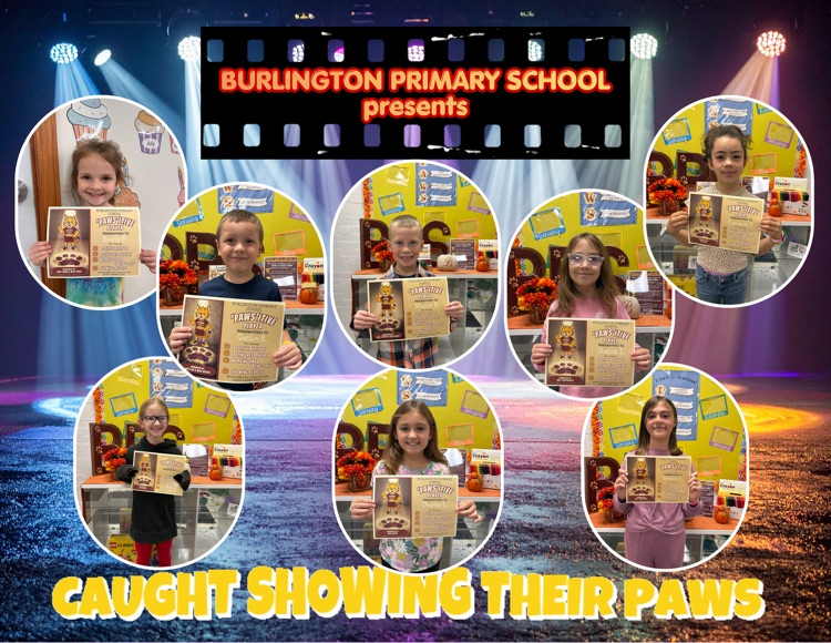 A photo of students holding a certificate that celebrates them for Showing Their PAWS.