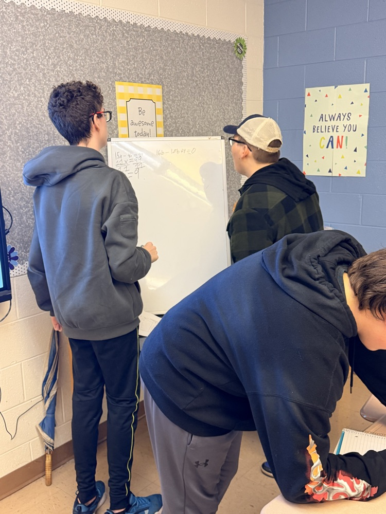 students working on white boards 