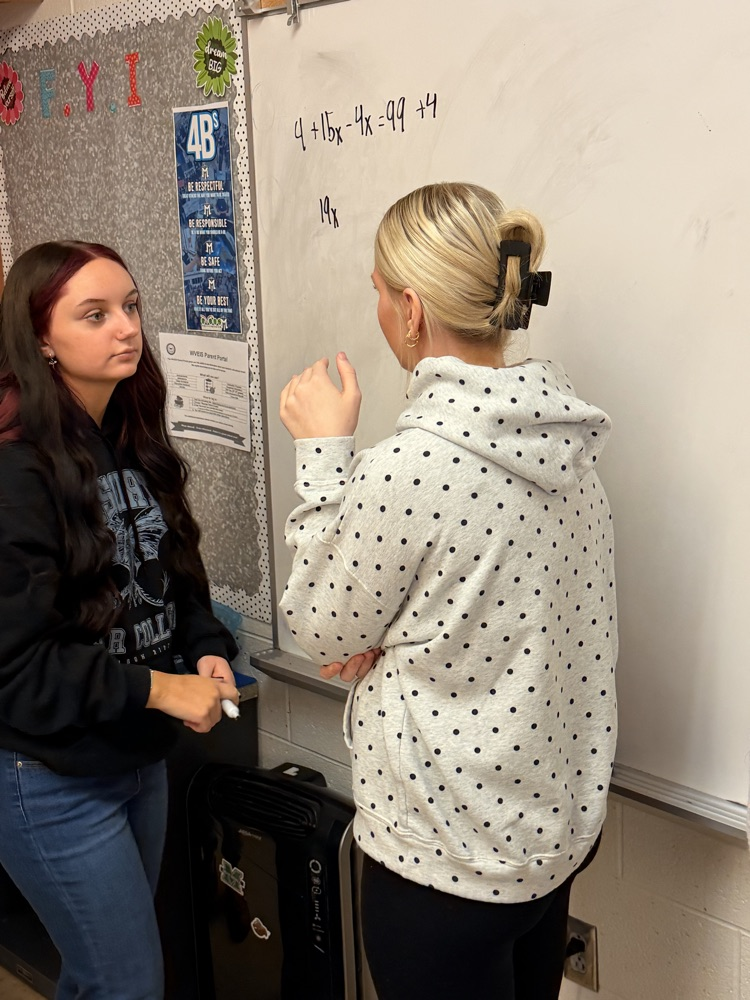 students working on white boards 