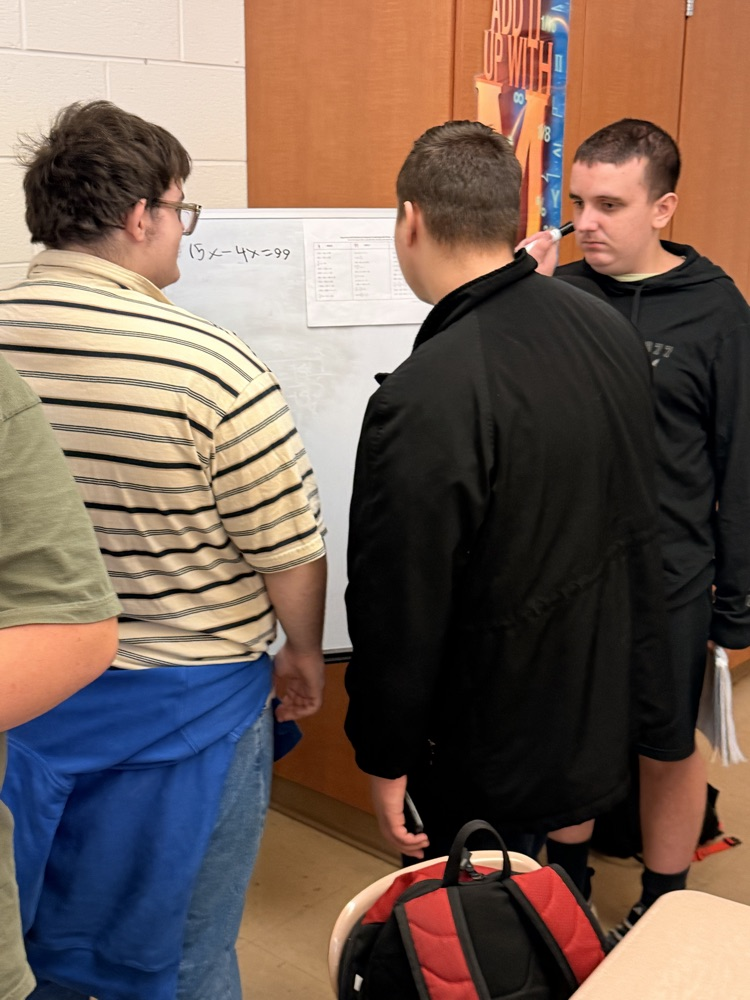 students working on white boards 