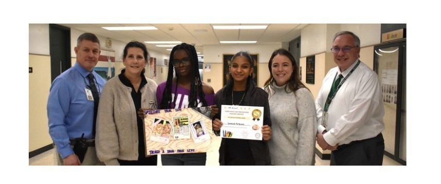 student with poster and adminstrators