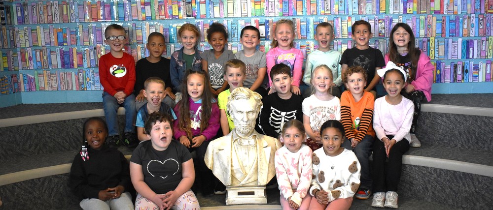 students in library with bust of Lincoln