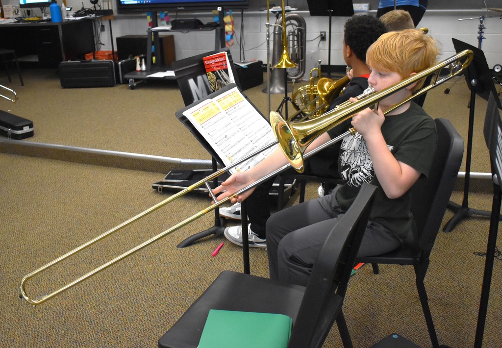 student in music class