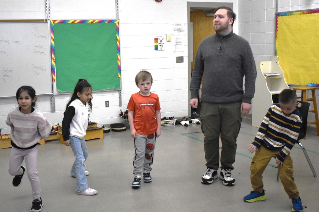 students and teacher dancing