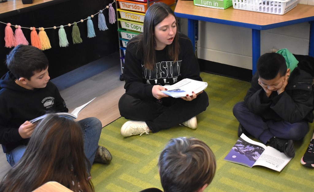 students and teacher reading