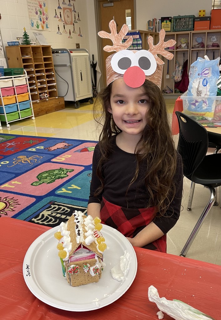 student with gingerbread house
