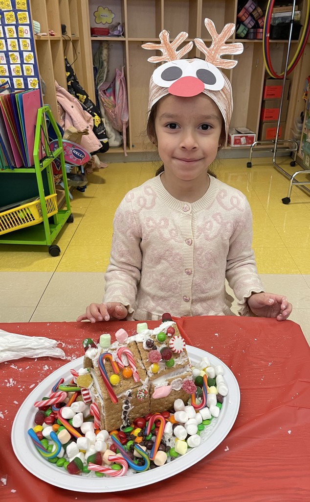 student with gingerbread house