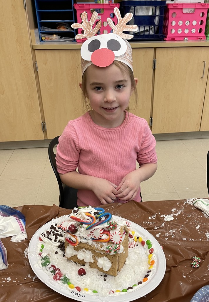 student with gingerbread house