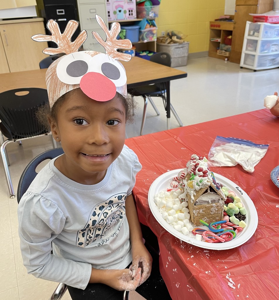 student with gingerbread house