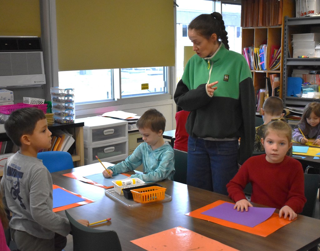 students and teacher in art class