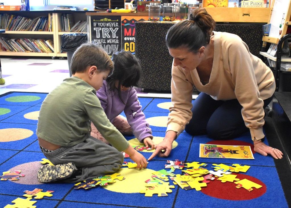 student with teacher in class