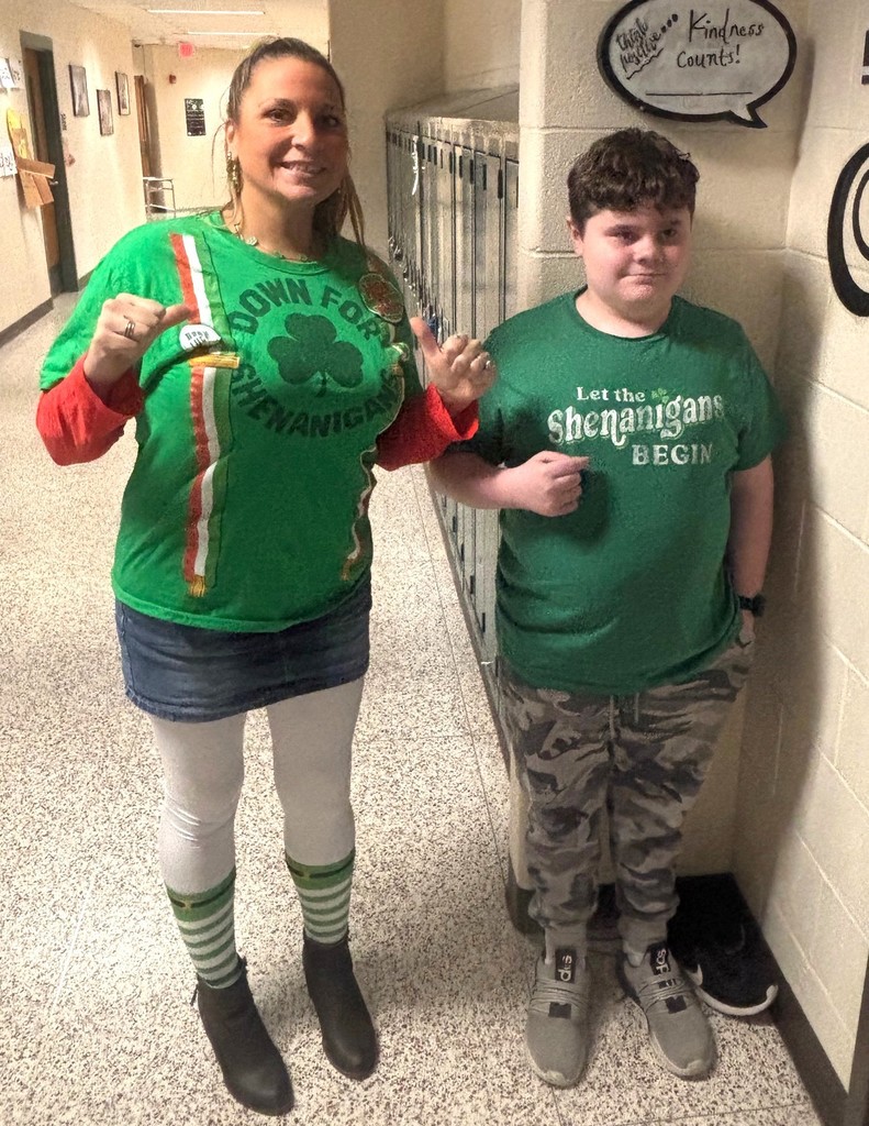 teacher and student in green attire