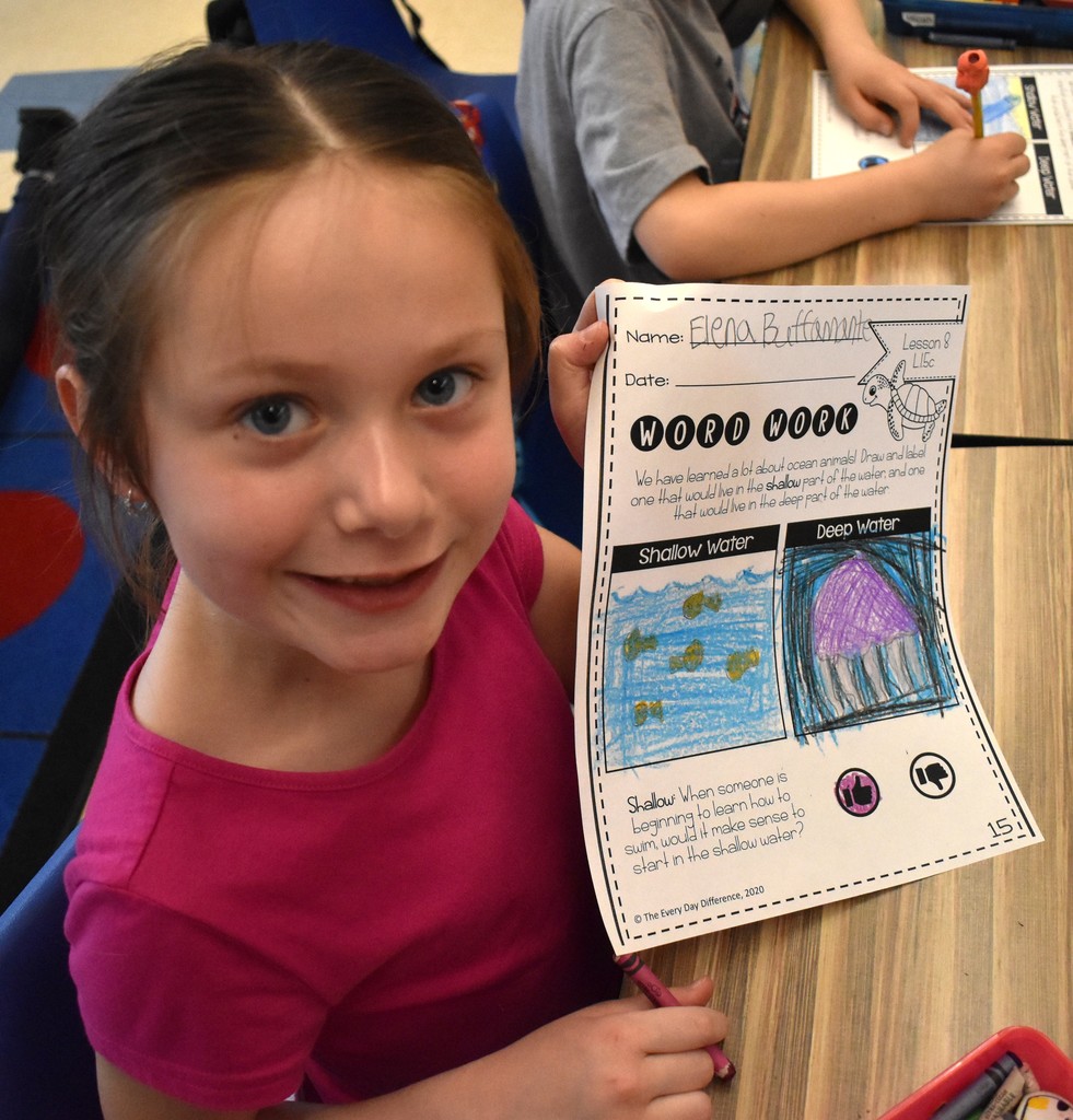 student in class with artwork