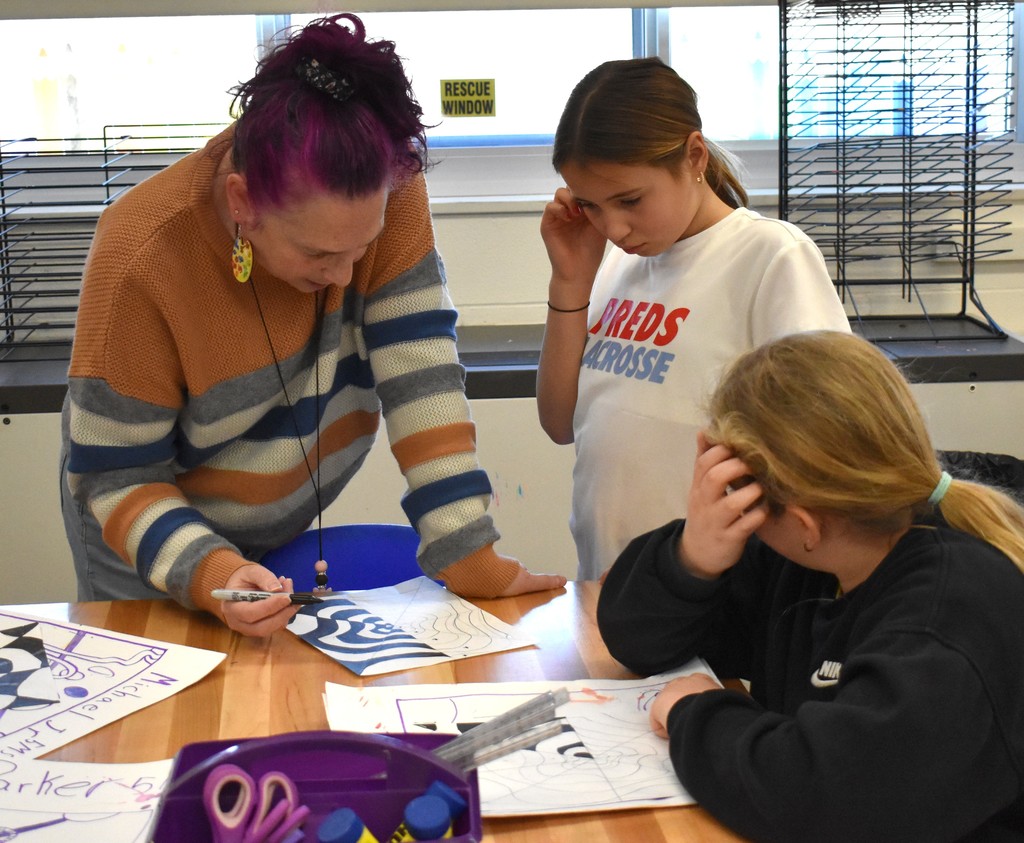 student and teacher in art class
